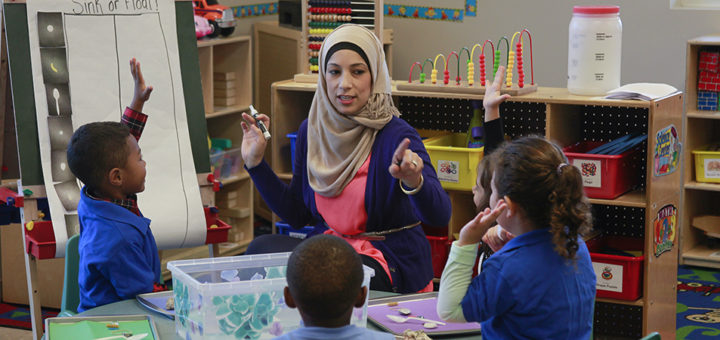 Image of Teacher speaking to little kids and calling on a student