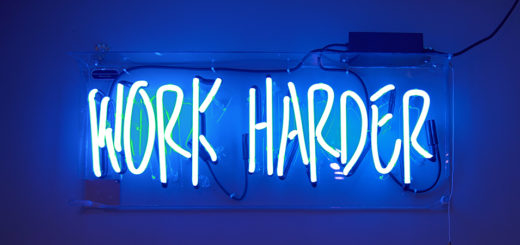 Neon sign that says, "Work Harder"