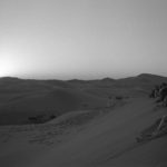 Black and white image of people at the desert