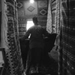 Black and white image of someone making a blanket
