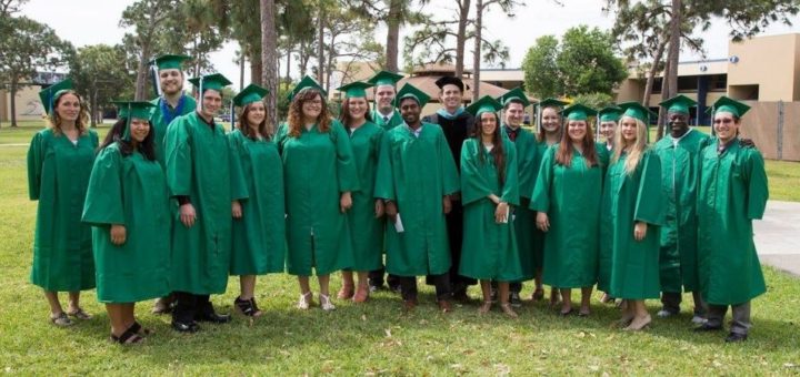 Group of EFSC Students wearing green graduation caps and gowns