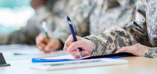 Image of people wearing military uniforms signing papers