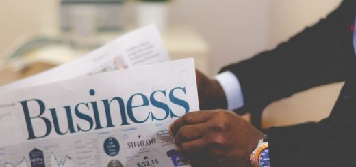 Image of a person holding a paper that says business