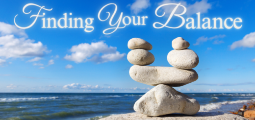 Image of rocks stacked on top of each other at the beach and the words say finding your balance